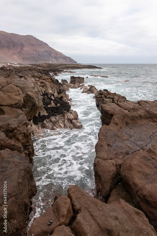 waves crashing on the rocks of the south coast of Arica