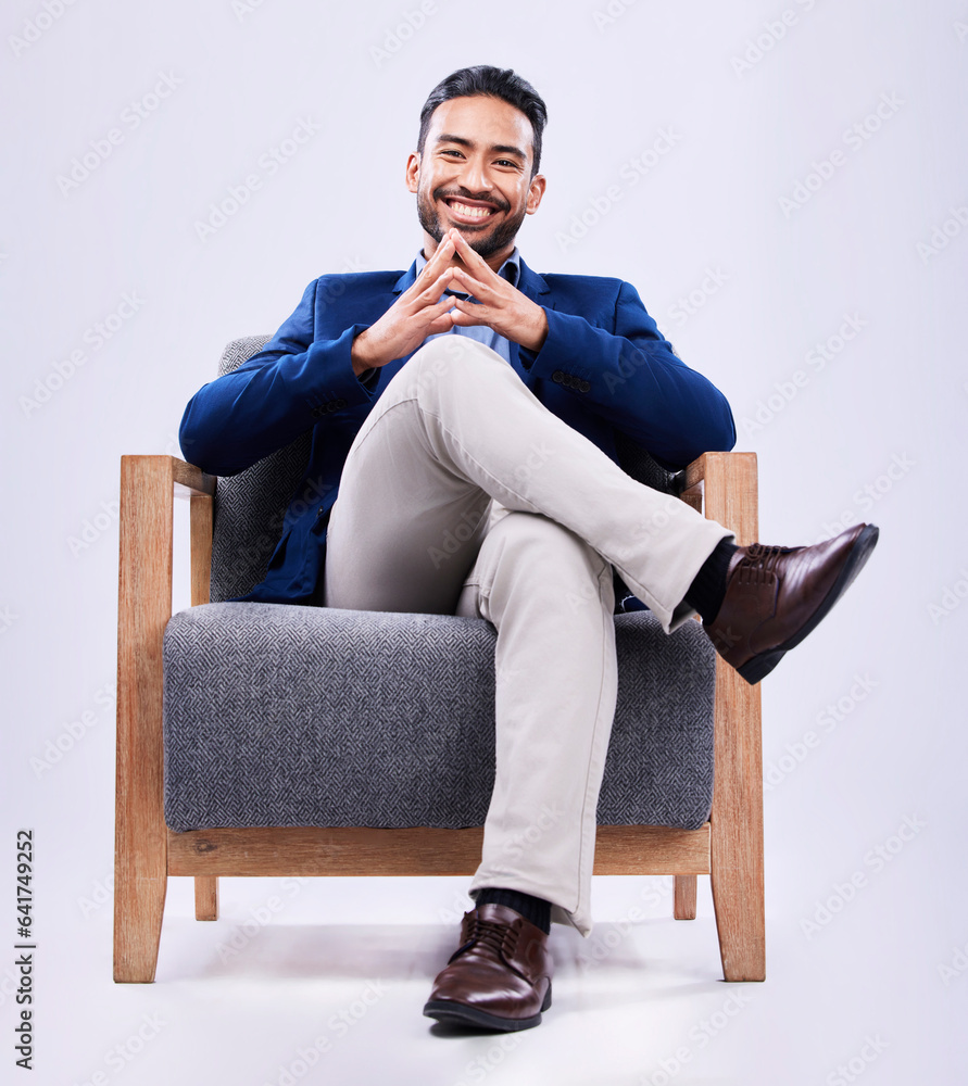 Portrait, confident and business man on chair in studio isolated on a white background. Professional