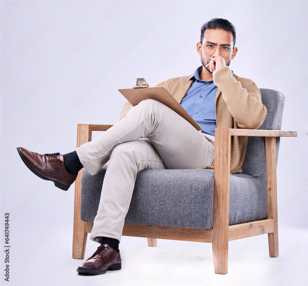 Portrait, serious and a man psychologist in a chair on a white background in studio to listen for di