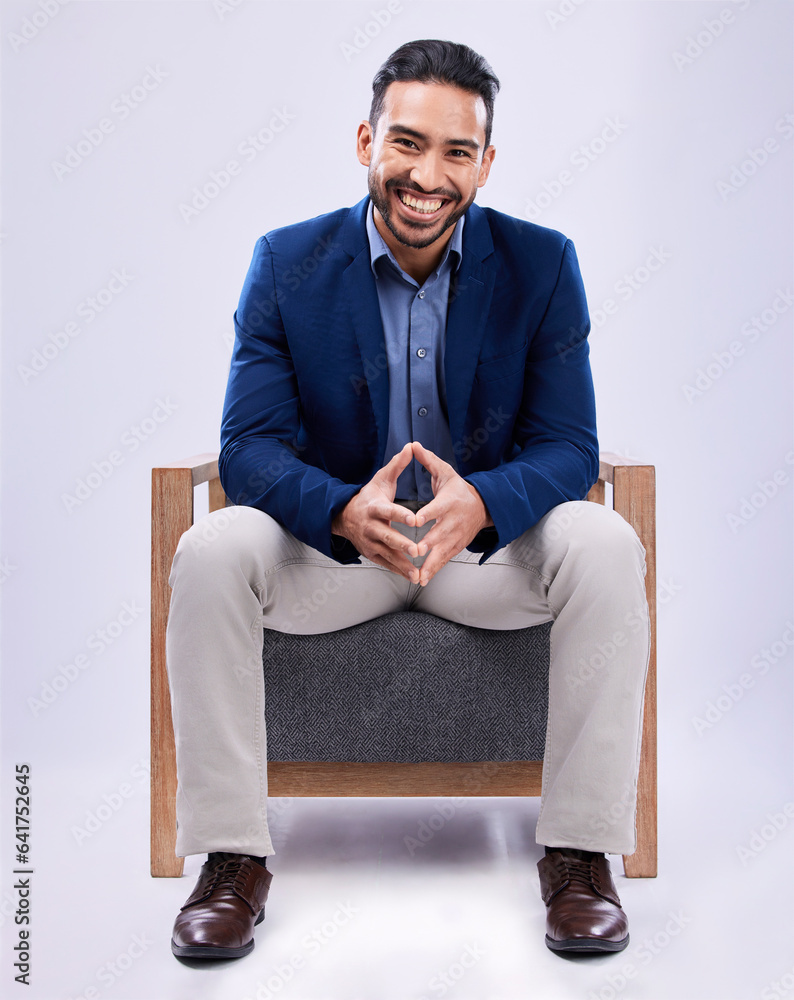 Portrait, happy and business man on chair in studio isolated on a white background. Professional att