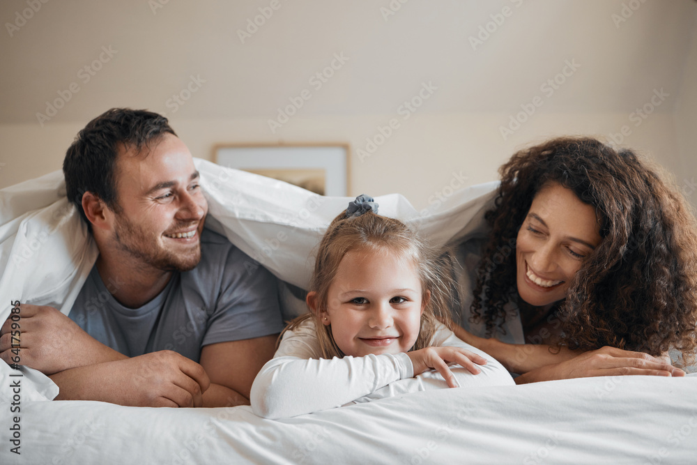 Love, happy and child in bed with her parents for bonding, relaxing and resting together with blanke