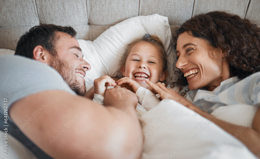 Family, bedroom and parents laughing with their daughter in the morning to relax after waking up tog