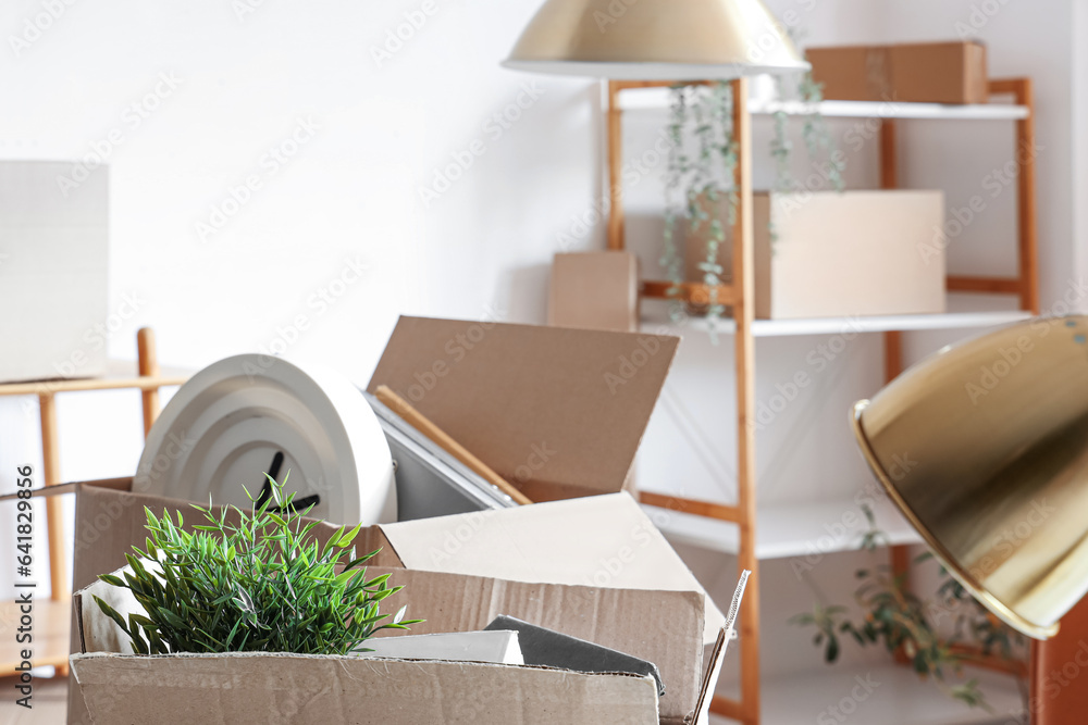 Cardboard boxes with things in office on moving day, closeup