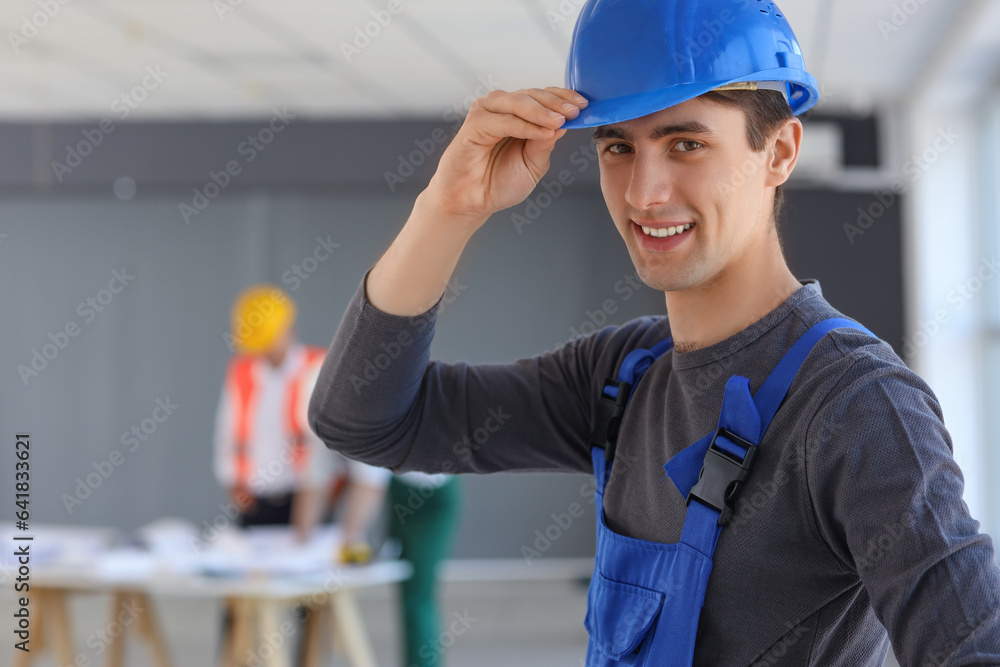 Male builder working in room, closeup