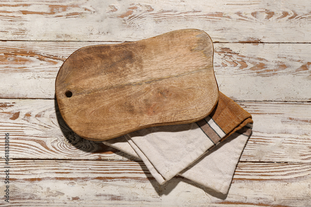 New cutting board on light wooden background