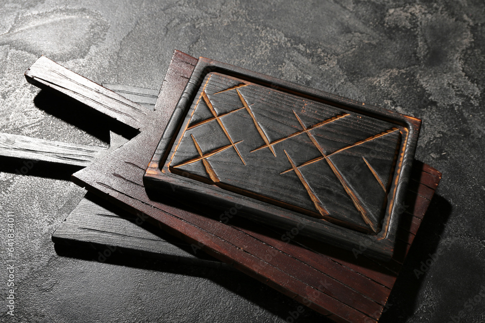 Wooden cutting boards on black background