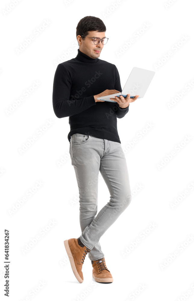 Young businessman working with laptop on white background