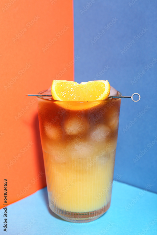 Glass of tasty orange espresso on color background