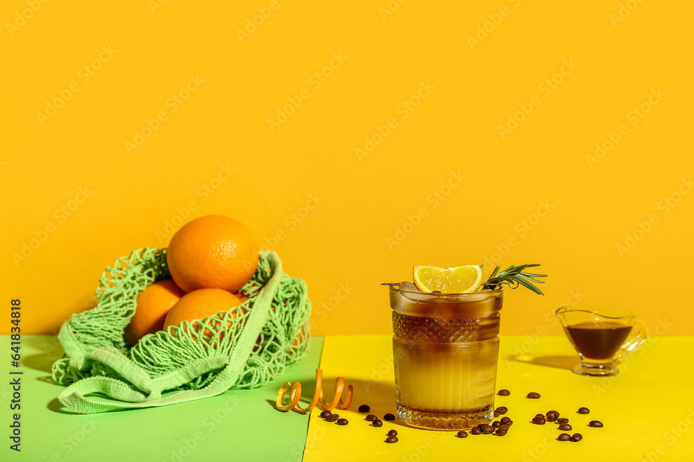 Glass of tasty orange espresso on color background