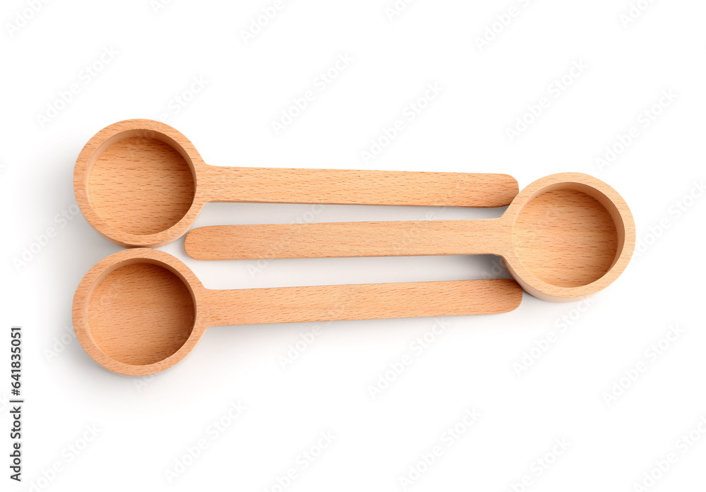 Empty wooden scoops isolated on white background