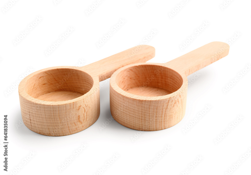 Empty wooden scoops on white background