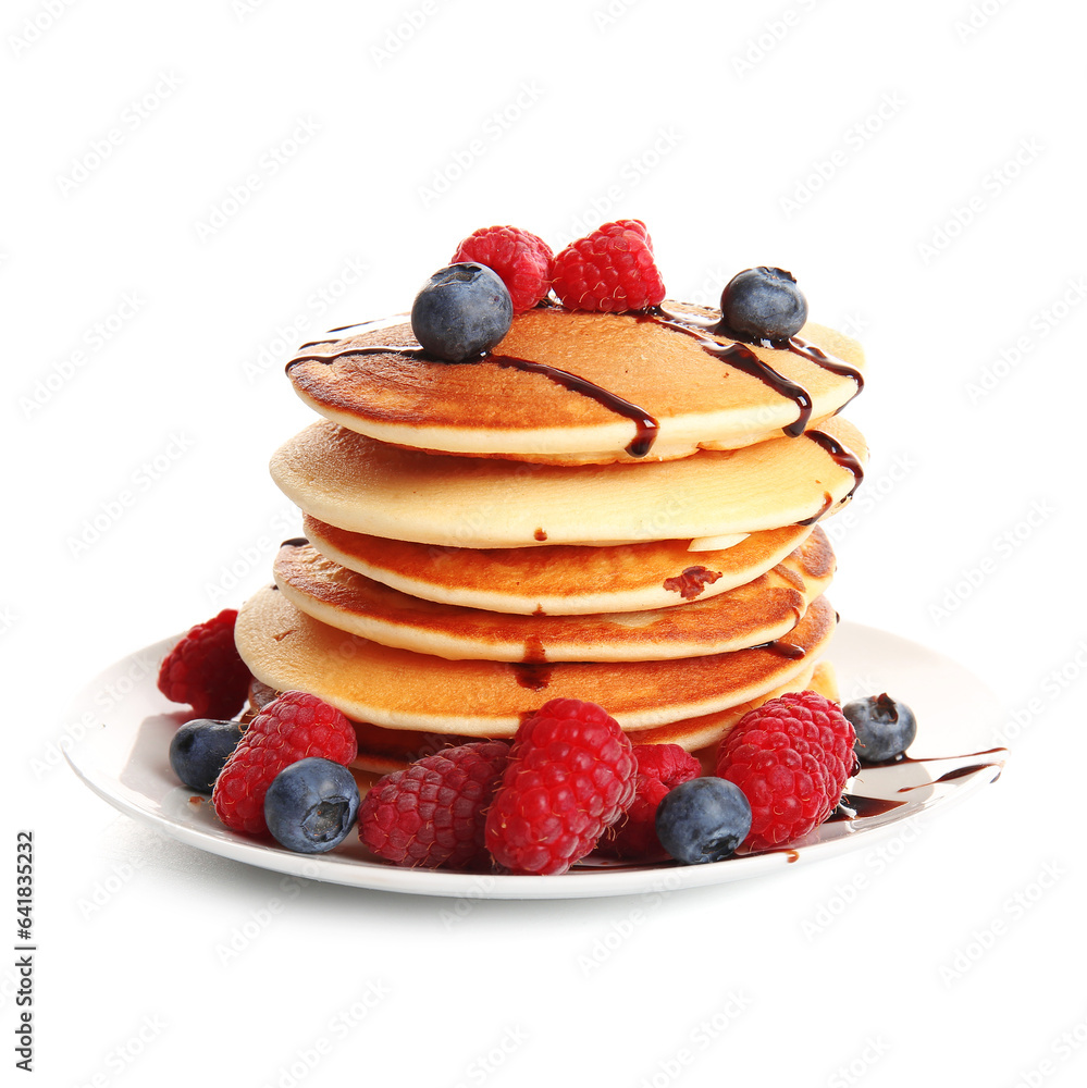 Plate of tasty pancakes with raspberries and blueberries isolated on white background