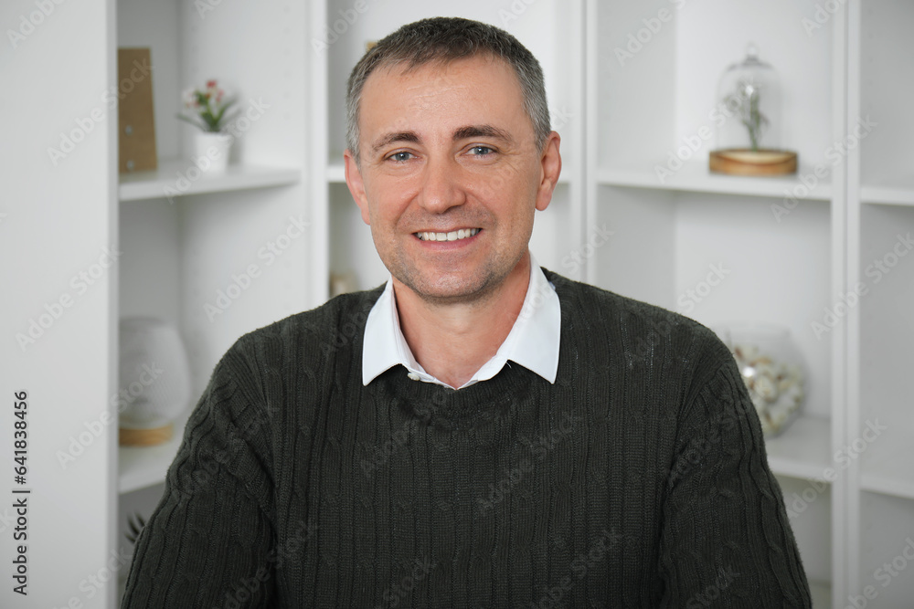 Portrait of happy mature man in room