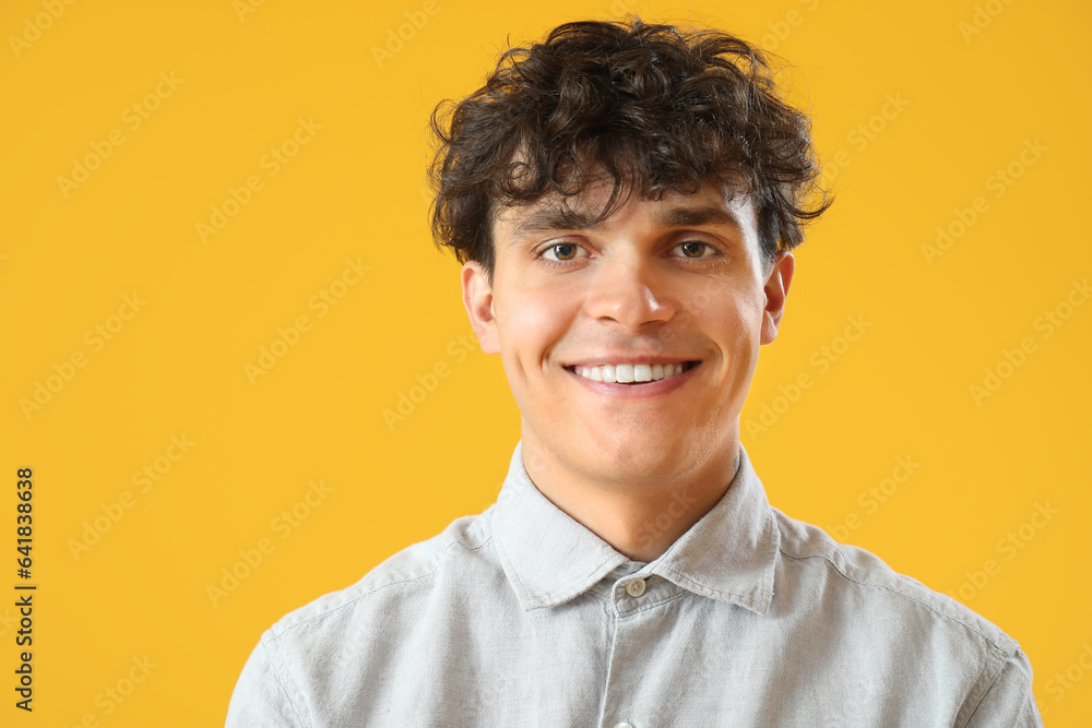 Portrait of handsome young man on orange background