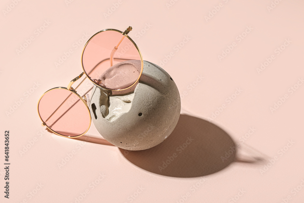 Stylish sunglasses on pink background