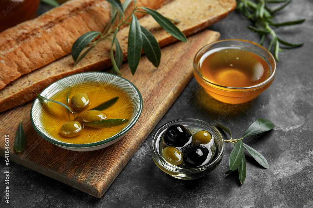 Bowls of fresh olive oil on black background