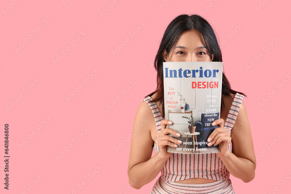 Thoughtful young beautiful Asian woman with magazine on pink background