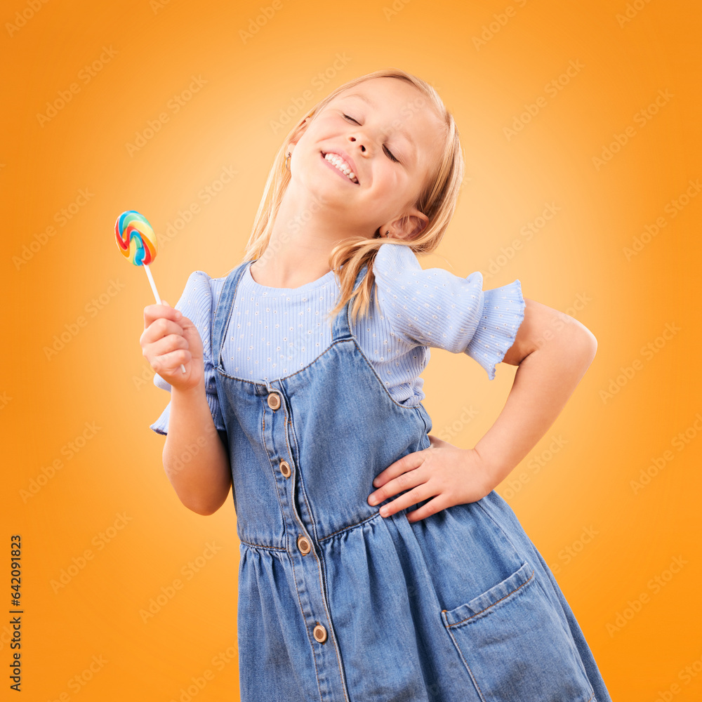 Happy, lollipop and girl child with candy, hungry for dessert .and isolated on an orange background 