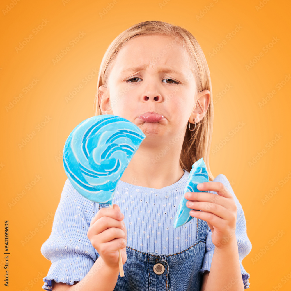 Portrait, children and sad girl with a broken lollipop on an orange background in studio looking ups