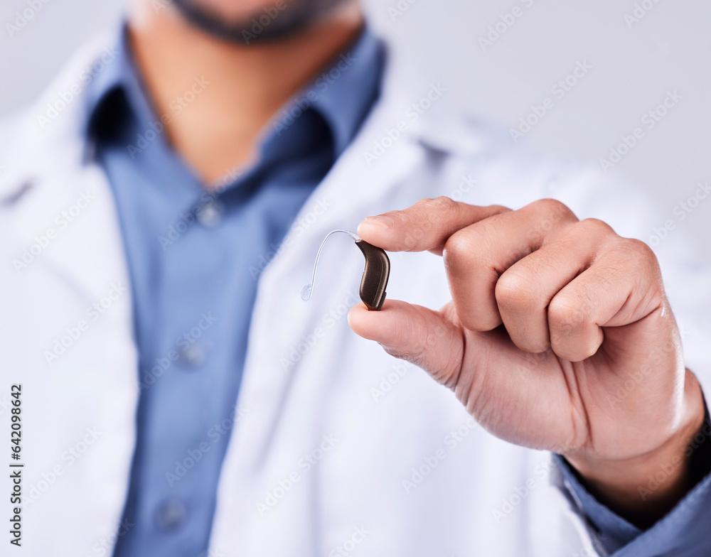 Closeup, hand and a hearing aid from a doctor for communication, medical support or service. Healthc