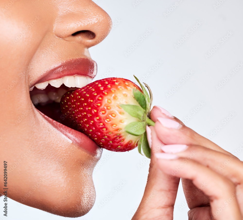 Diet, closeup and woman eating strawberry in a studio for healthy wellness snack for nutrition. Heal