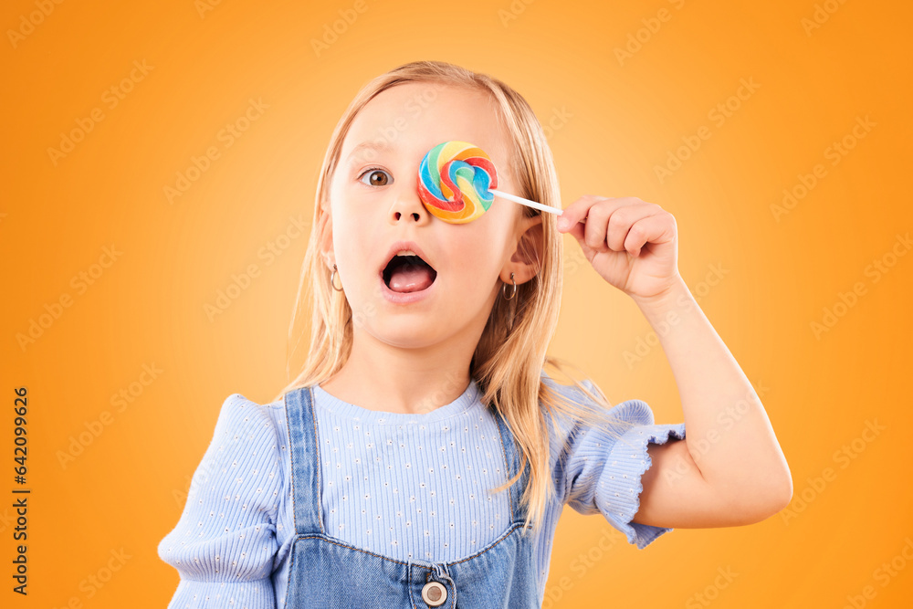 Portrait, cute and a child with a lollipop on a studio background for food, candy or crazy expressio