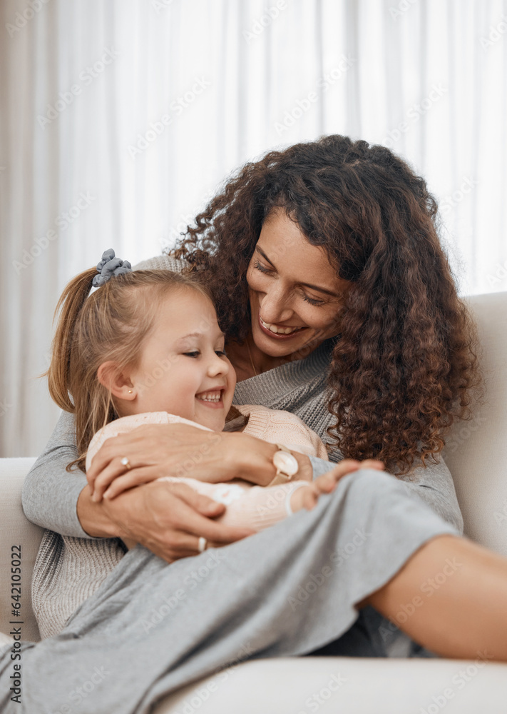 Love, hug and mother with girl child on a sofa happy, playing and bonding in their home together. Fa