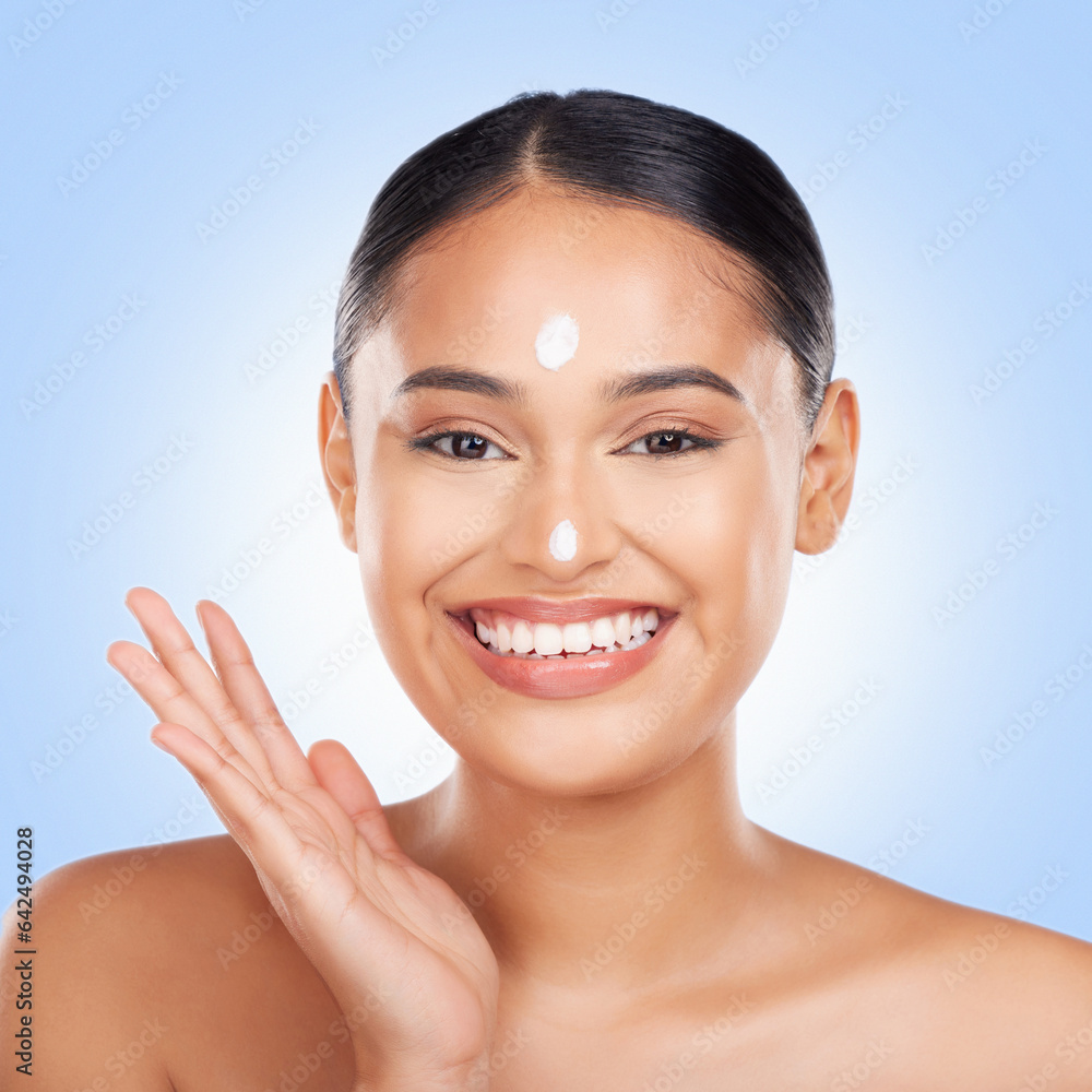 Portrait, smile and woman with cream, cosmetics and dermatology on blue studio background. Face, per