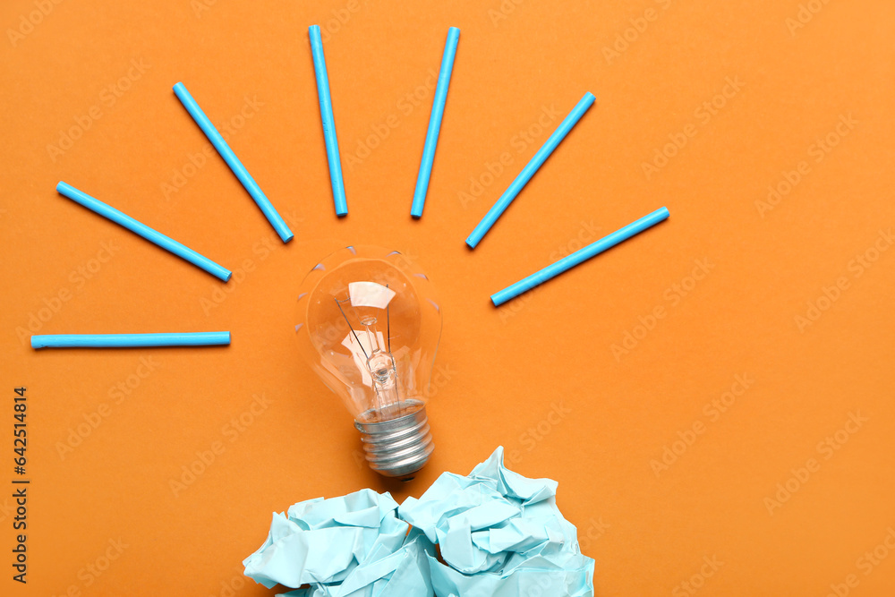 Light bulb with crumpled paper on color background. Logic concept