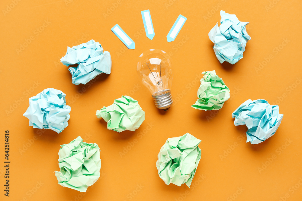 Light bulb with crumpled paper on color background. Logic concept