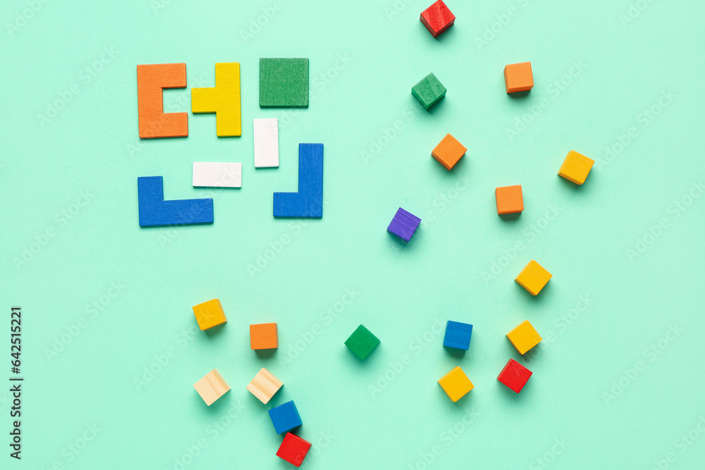 Colorful blocks with cubes on green background. Logic concept