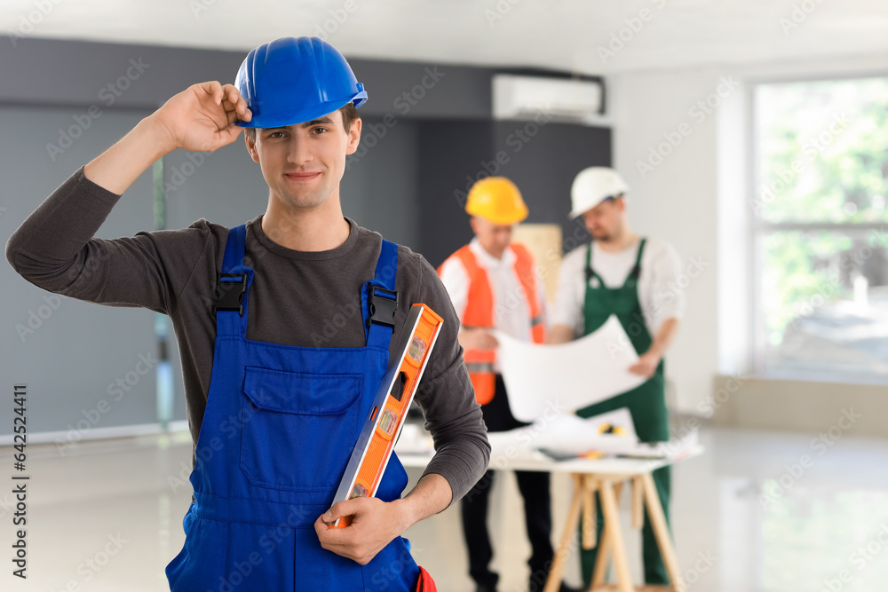 Male builder working in room