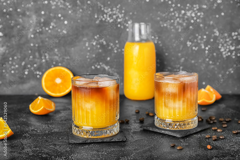 Glasses of cold orange espresso on table