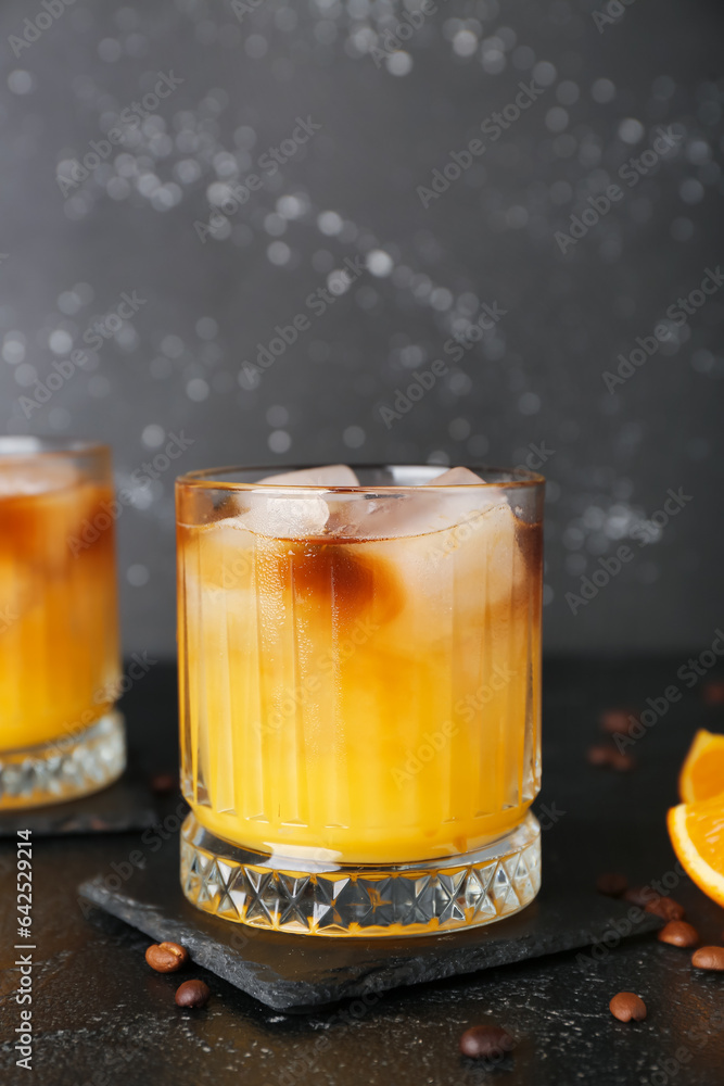 Glass of cold orange espresso on table