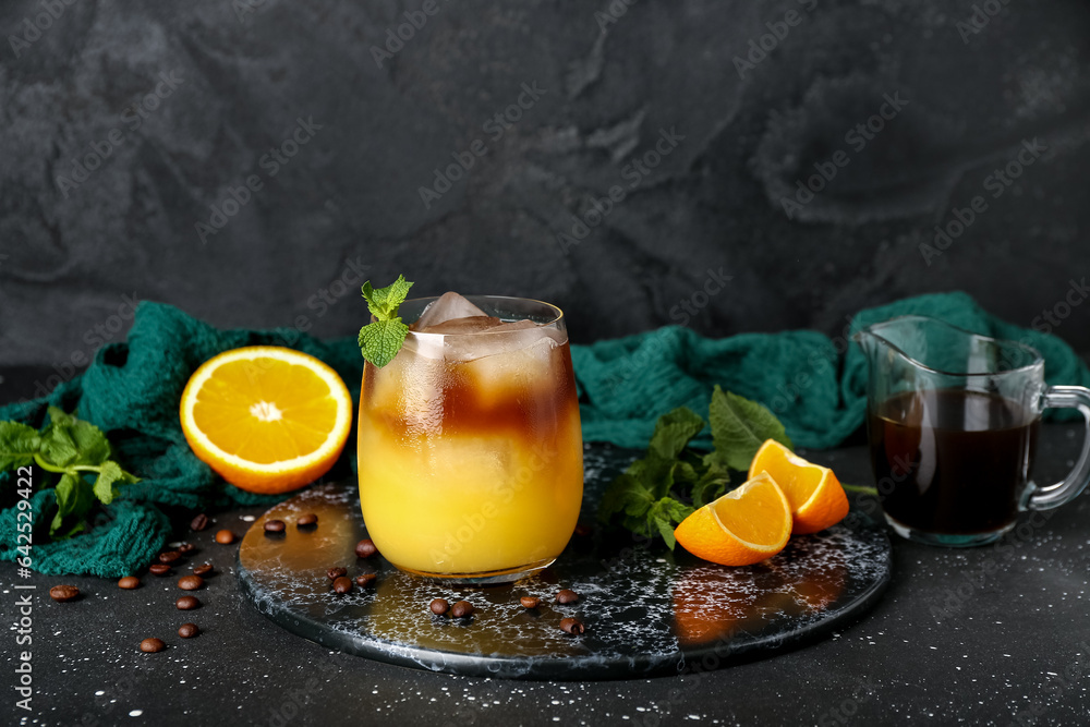 Glass of cold orange espresso on table