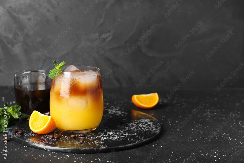 Glass of cold orange espresso on table