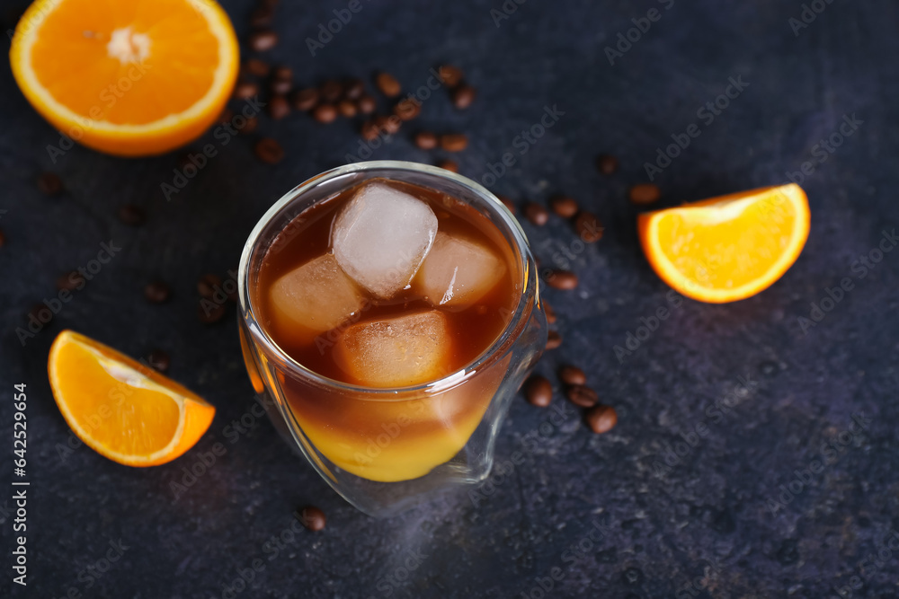 Glass of cold orange espresso on dark blue background