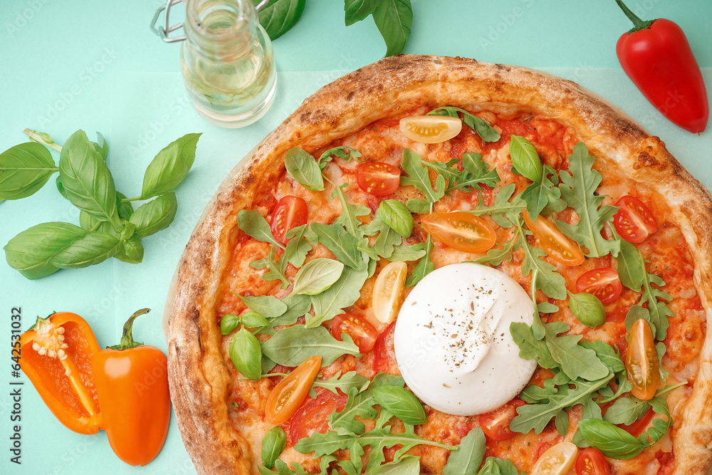 Tasty pizza with Burrata cheese on green background