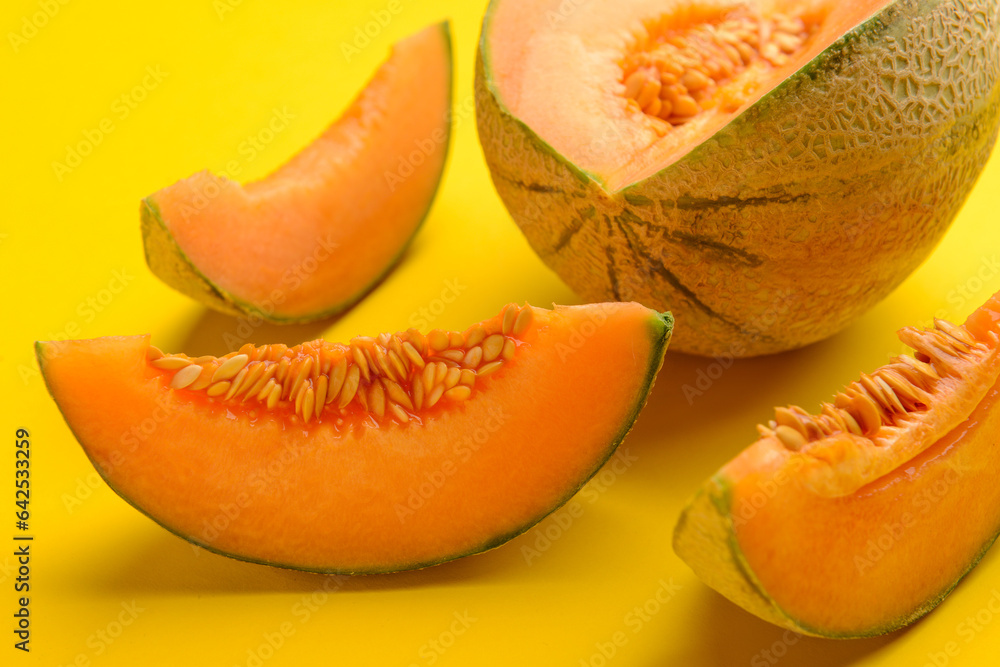 Sliced ripe melon on yellow background