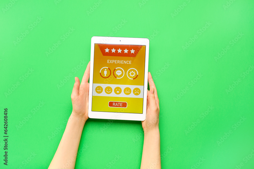 Woman holding tablet computer with experience survey on green background