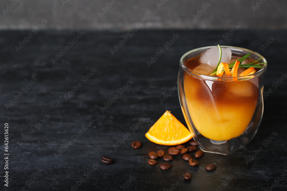 Glass of cold orange espresso on table