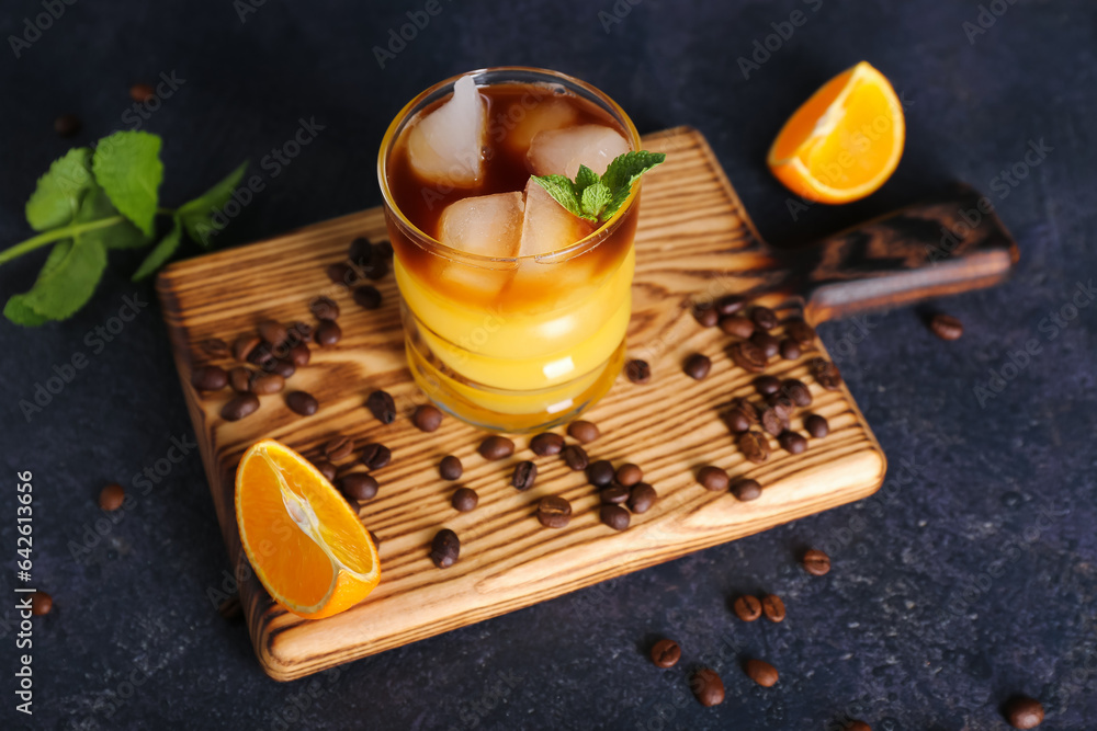 Glass of cold orange espresso on dark blue background