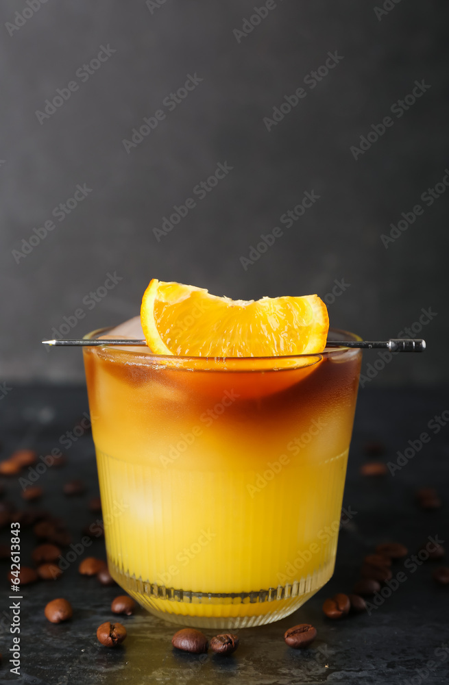 Glass of cold orange espresso on table