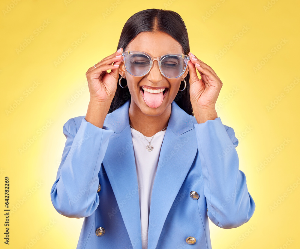 Funny, woman smile and sunglasses with tongue out, comedy and silly face in a studio. Yellow backgro