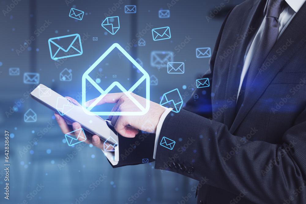 Businessman hands using cellphone with glowing email letter icons on blurry office interior backgrou