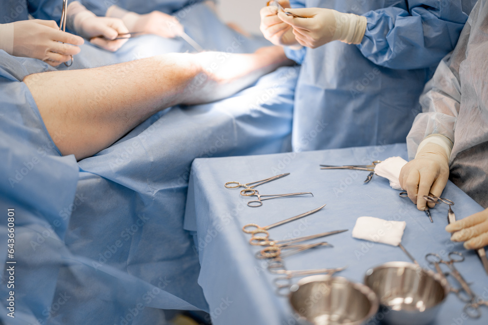 Surgery treatment in progress, close-up on table with medical tools. Concept of real invasive surger