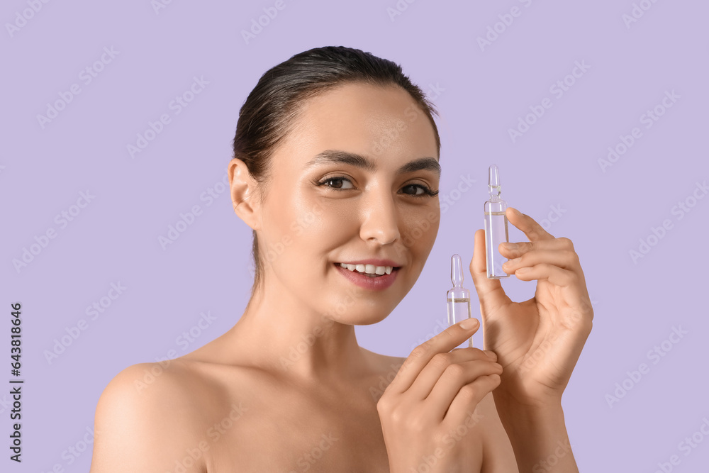 Beautiful young woman with ampules on lilac background, closeup