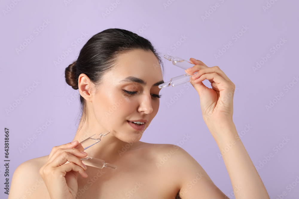 Beautiful young woman with ampules on lilac background, closeup