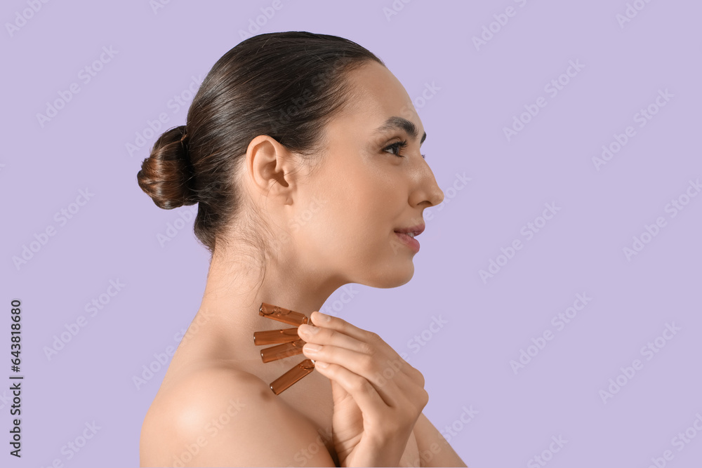 Beautiful young woman with ampules on lilac background, closeup