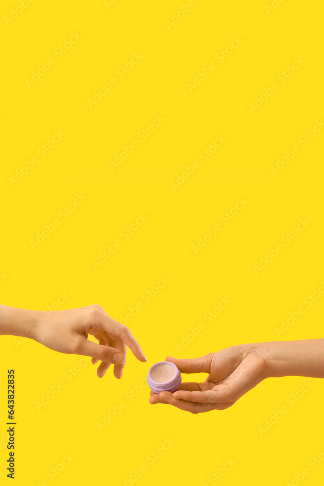 Women with makeup product on yellow background